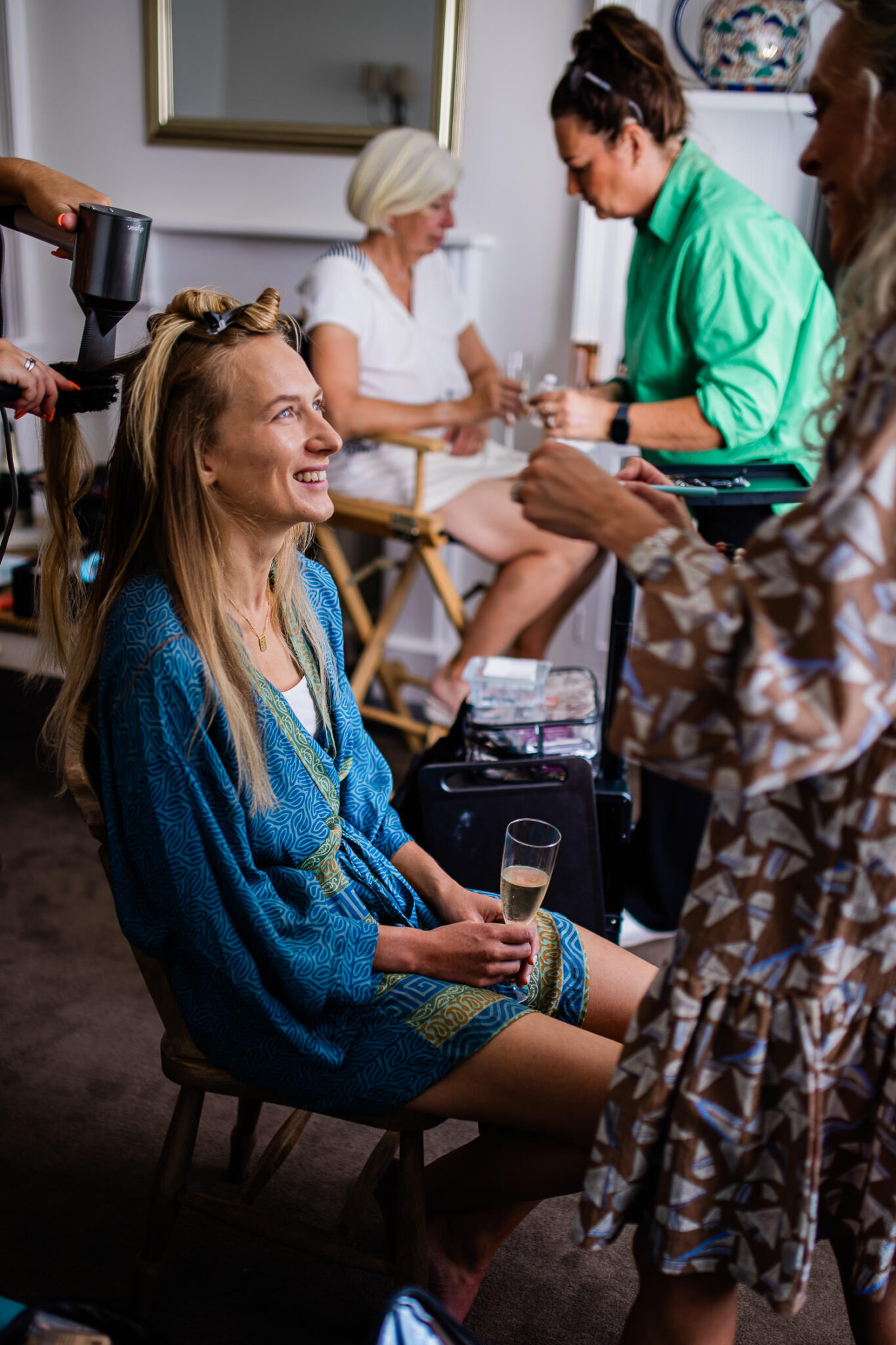 Bride smiling as she has her makeup done, before the wedding at The Grain Store.