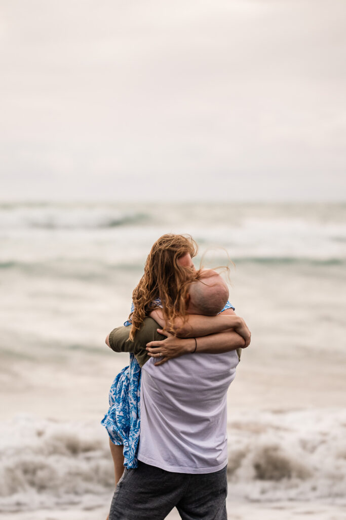 A boyfriend and his girlfriend kiss, in the sea