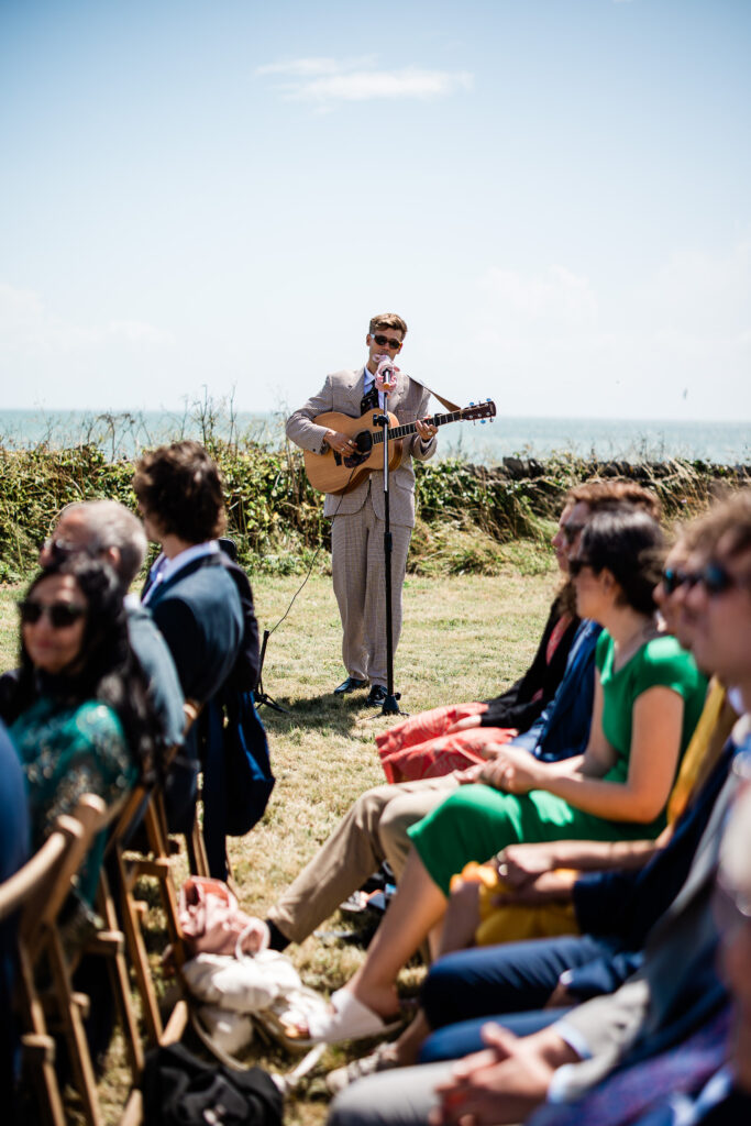 An open air ceremony with a guitarist