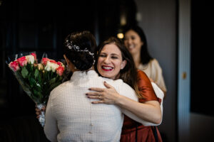 A bride hugs her bridesmaids before the wedding, during a documentary photography capture