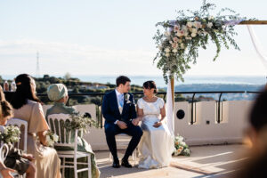 A romantic moment between a bride and groom during their outdoor wedding ceremony at Chateau de cremat