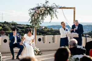 A candid moment during speeches at an outdoor wedding ceremony Nice