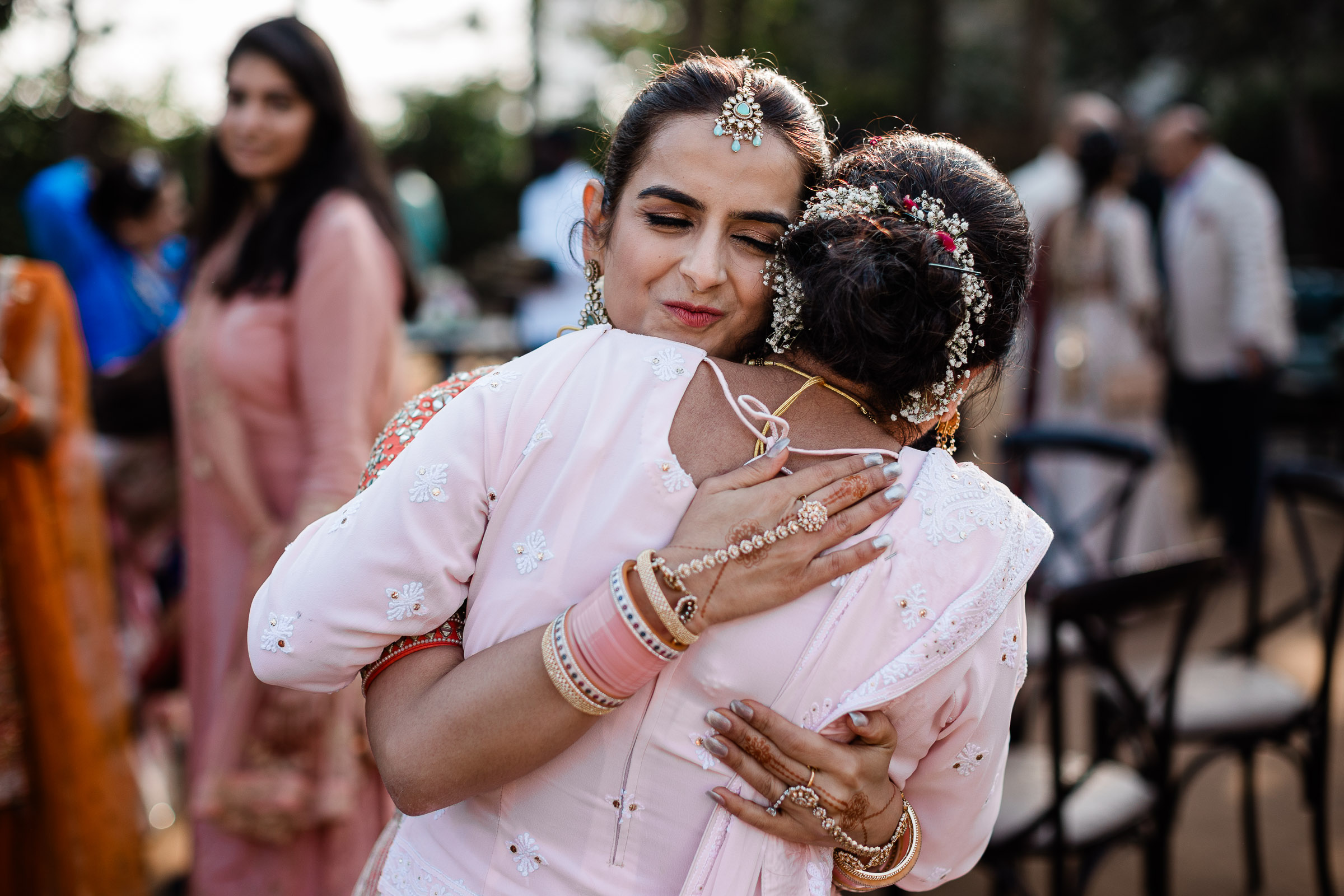 Documentary wedding photographer capture of a sentimental moment during an Indian wedding reception