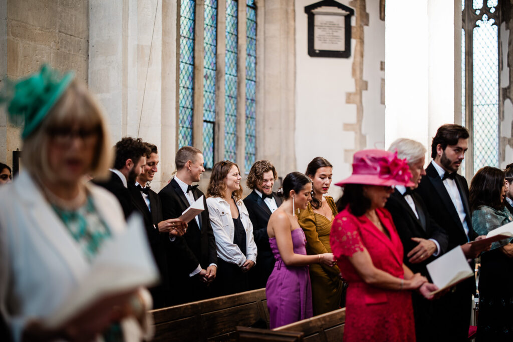 Candid Cotswolds wedding photography of guests during a wedding ceremony