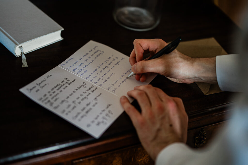 A guest writes a note before the wedding ceremony begins
