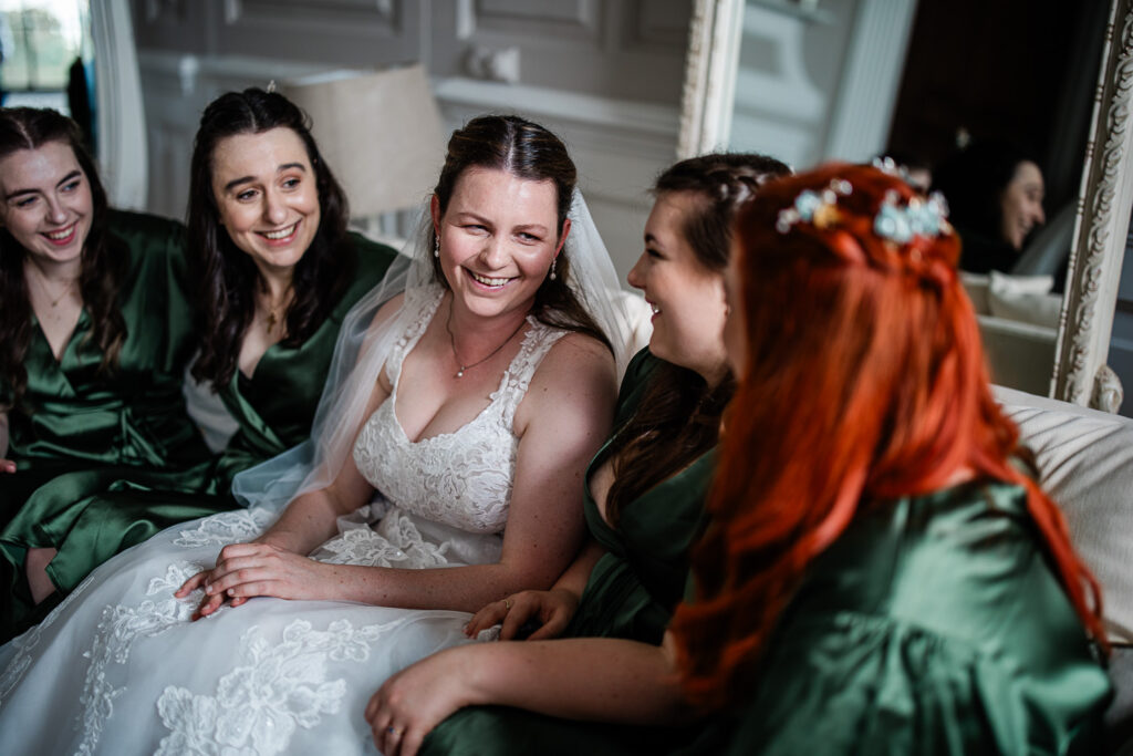 A bride chats with her bridesmaids during the wedding morning