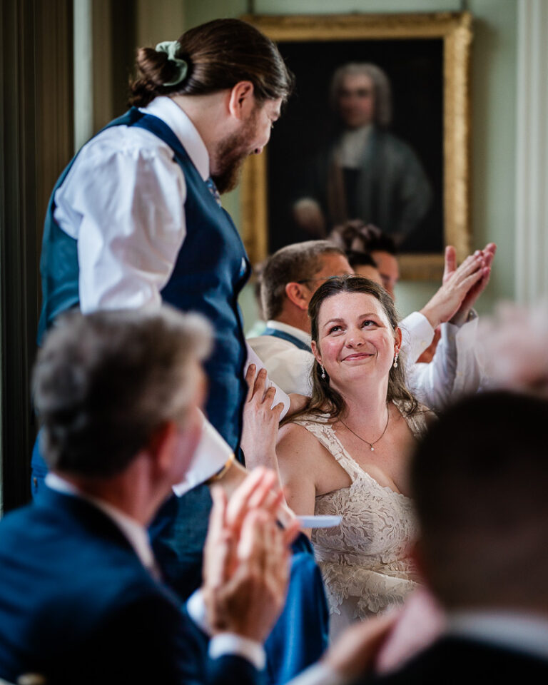 A tender moment between a bride and groom during wedding speeches