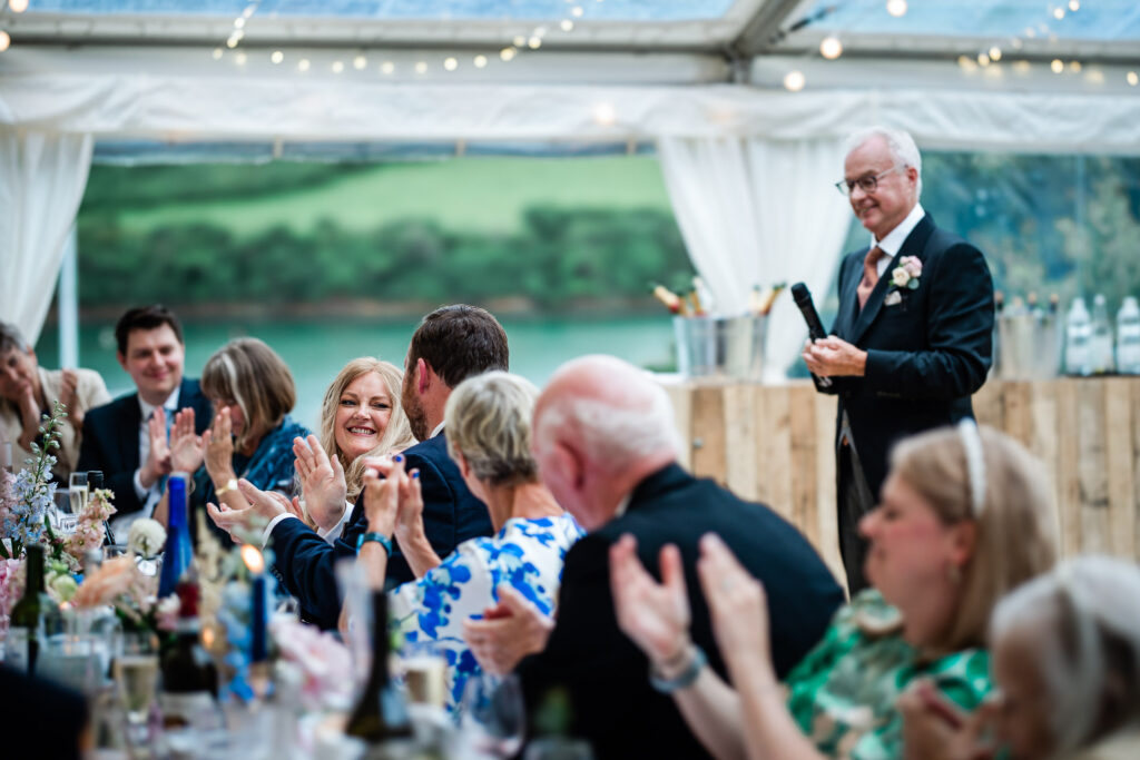 documentary wedding photography during speeches at a marquee reception in Salcombe, Devon