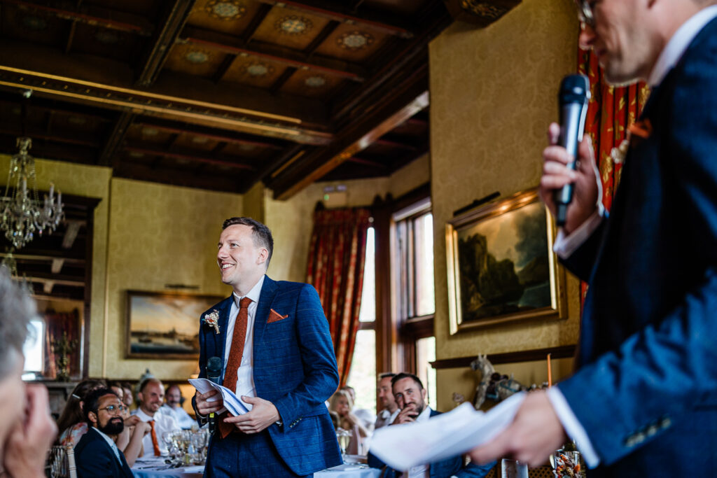Guests smile at the speeches for a luxury manor house wedding