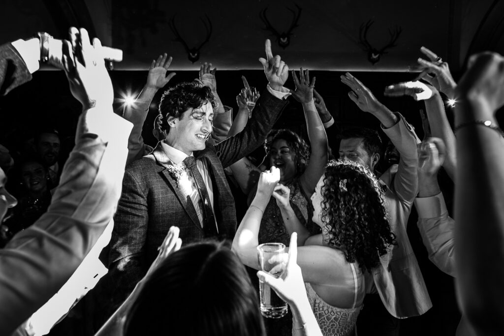 The bride and groom dance, surrounded by their closest friends