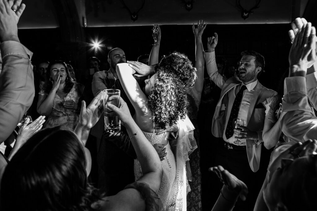 The bride and groom dance, surrounded by their closest friends
