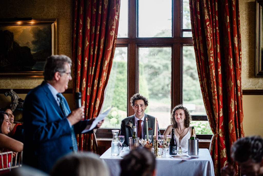 documentary capture of the wedding speeches captured by a wedding photographer at huntsham court