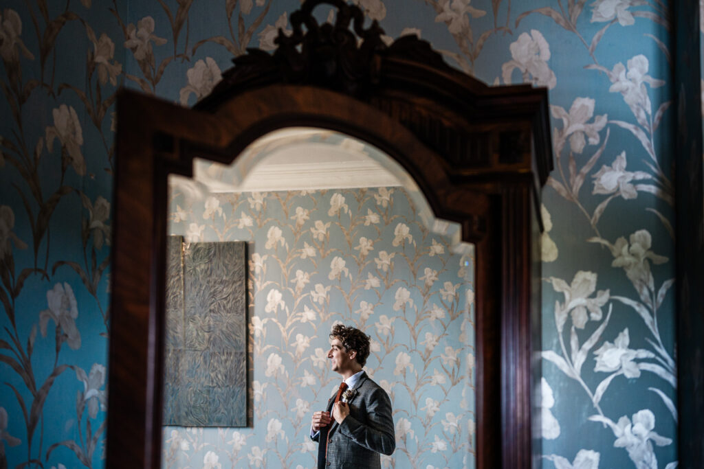 the groom prepares for the ceremony, captured by a wedding photographer at huntsham court