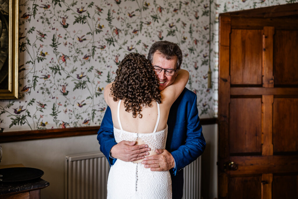 wedding photographer at huntsham court capture of a bride and her father embracing