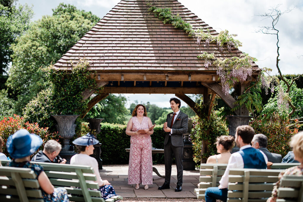 the groom and maid of honour wait for the bride to arrive