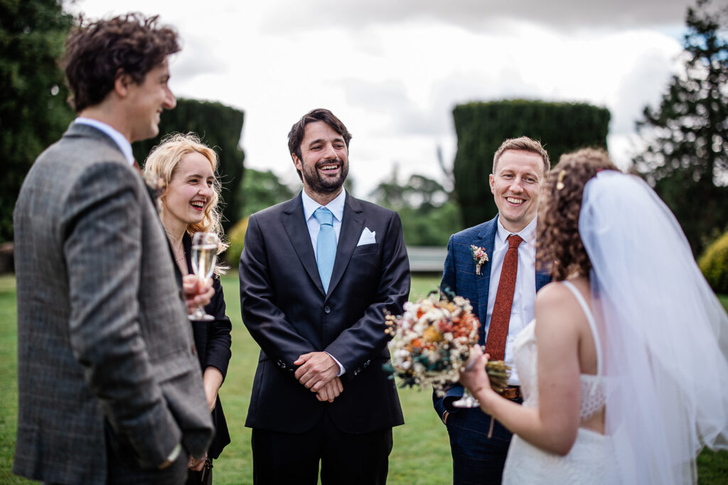 guests chatting captured by a wedding photographer at huntsham court