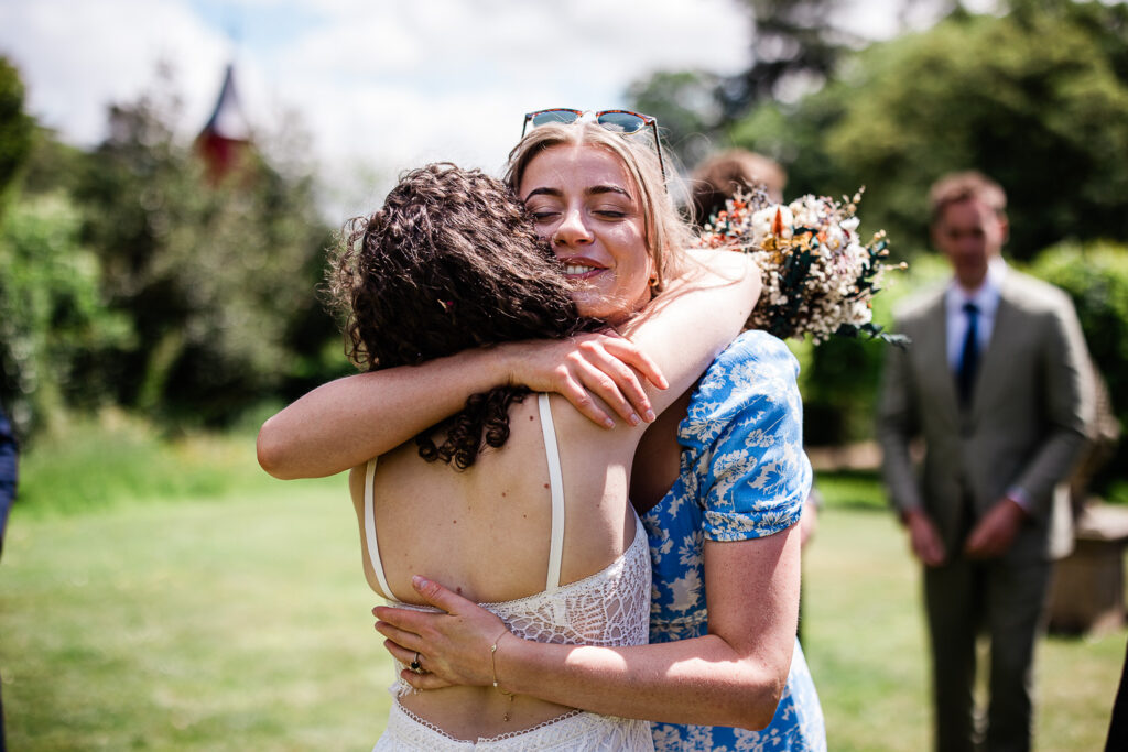 a bride hugs her friend