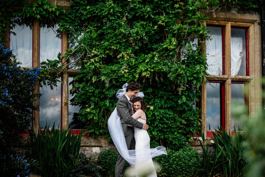 a bride and groom hug during their manor house wedding
