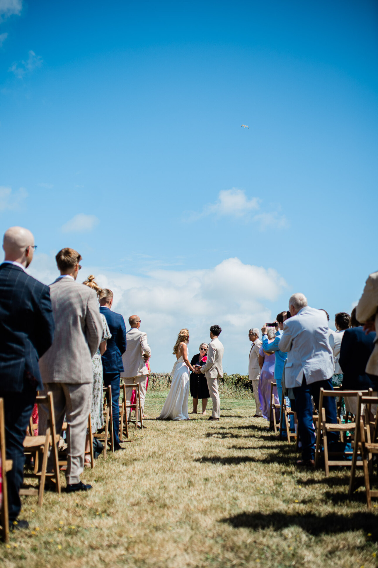 A bride and groom exchange their wedding vows at the aisle, at their english seaside wedding ceremony at The Grain Store.