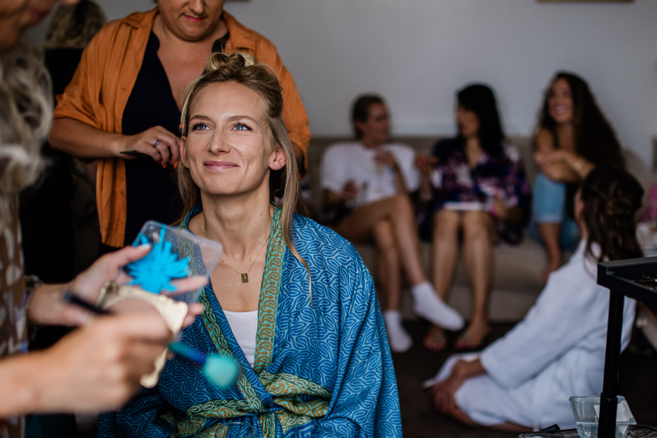 Bride and her friends getting ready at bridal prep.