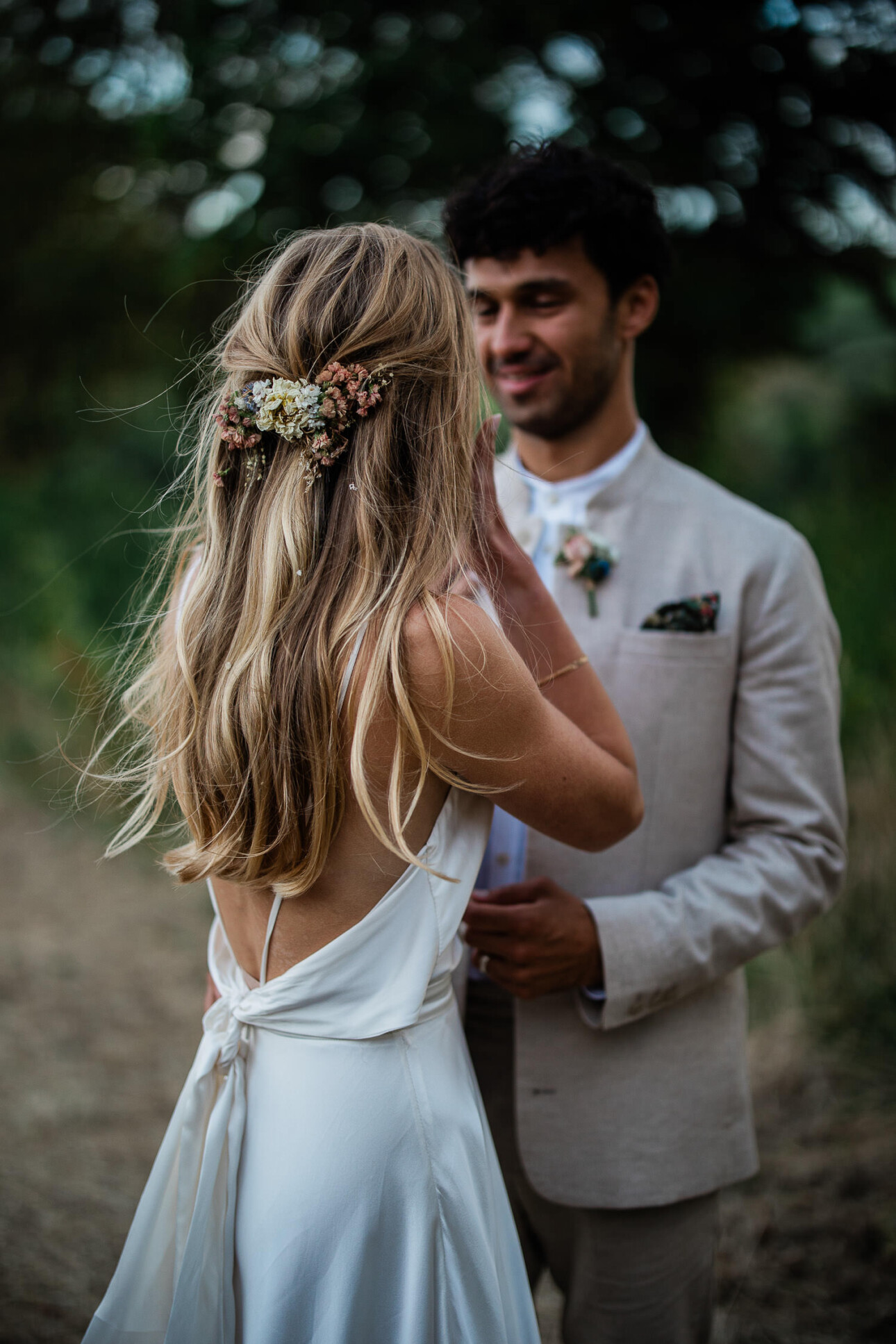 A groom smiles down at the bride, during a wedding portrait session with photographer Laura Rosemary Photography.