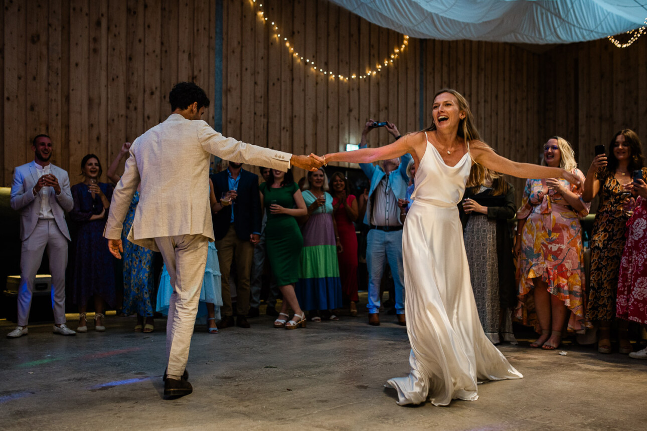 A bride and groom enjoying their first dance, during the wedding reception.