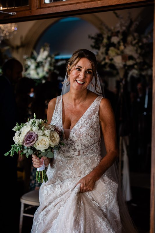 A bride smiles at her friends after the wedding ceremony.