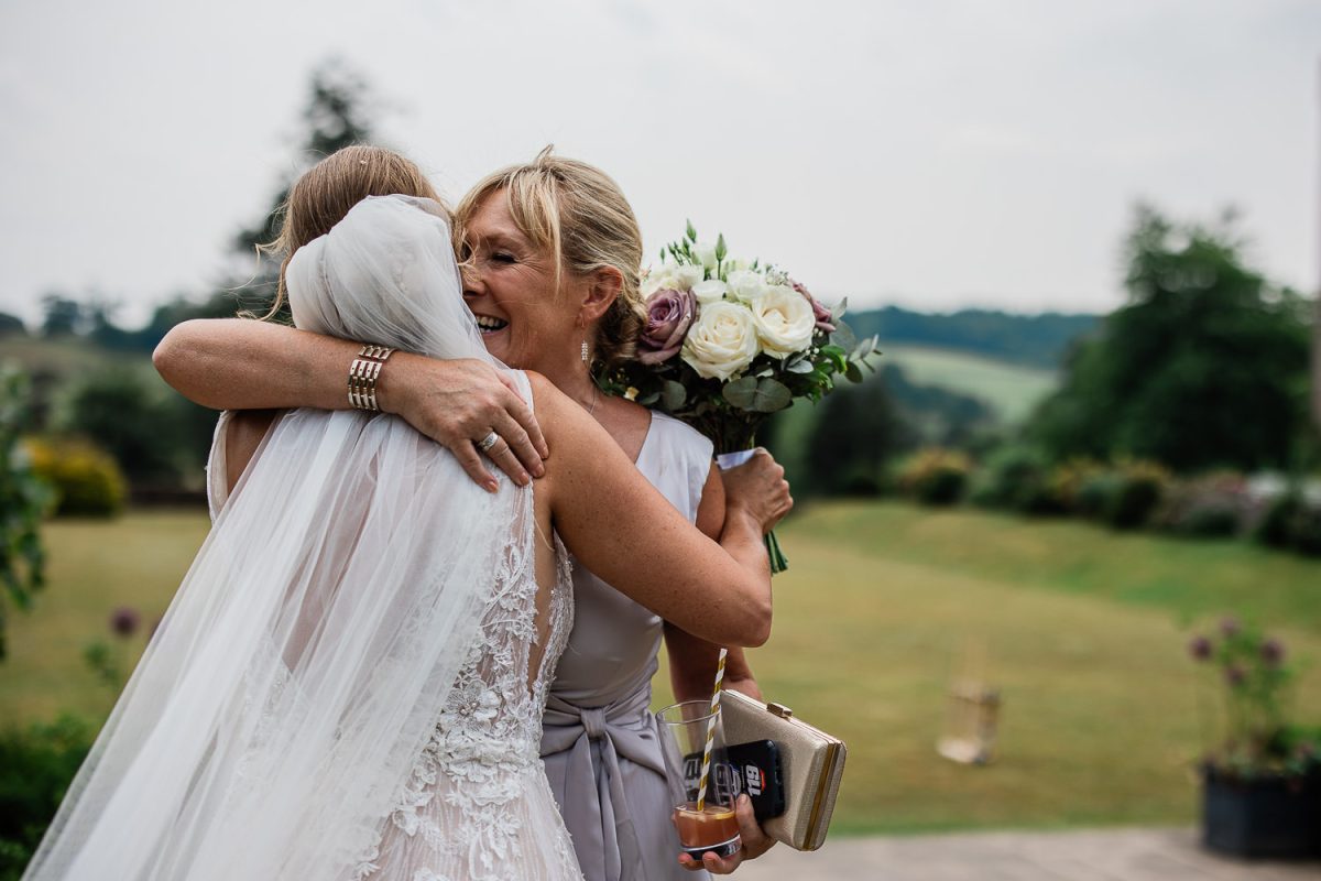Bride and her mother share a emotional hug, during the wedding reception at Huntsham Court wedding venue in Devon.