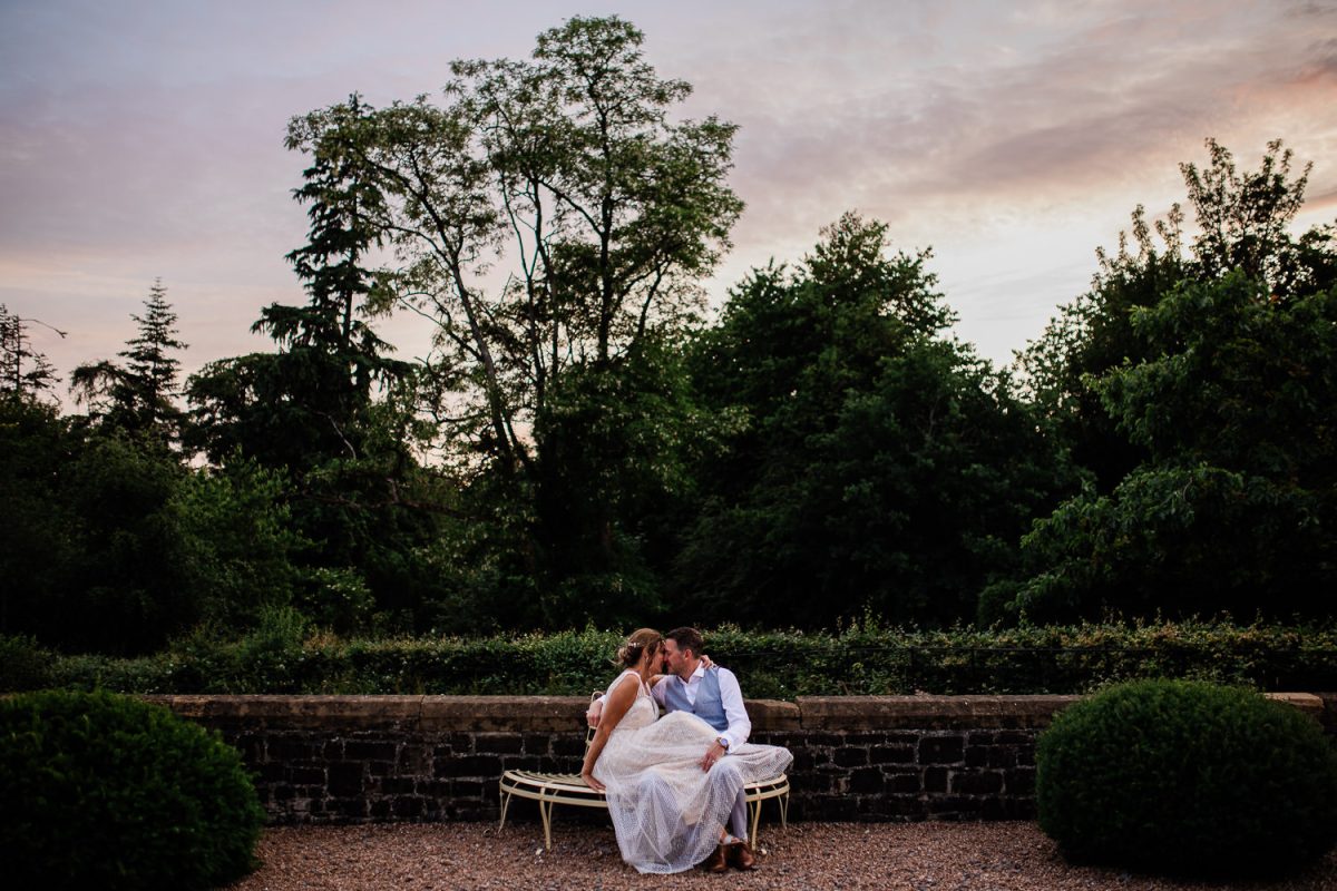 A bride and groom have an intimate moment away from the wedding, whilst enjoying the sunset at Huntsham Court in Devon.