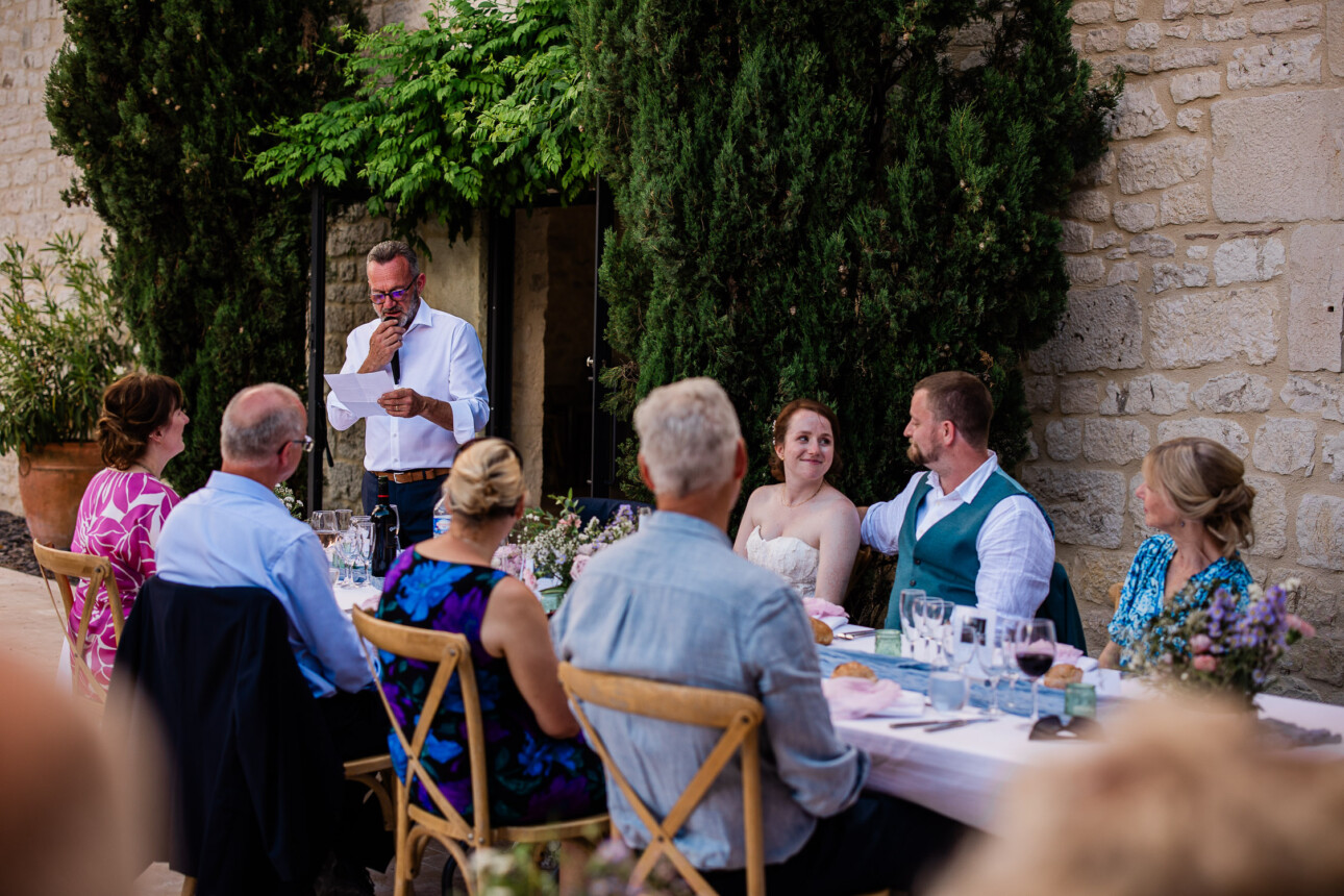 A bride and groom exchange a loving look, during the wedding speeches.