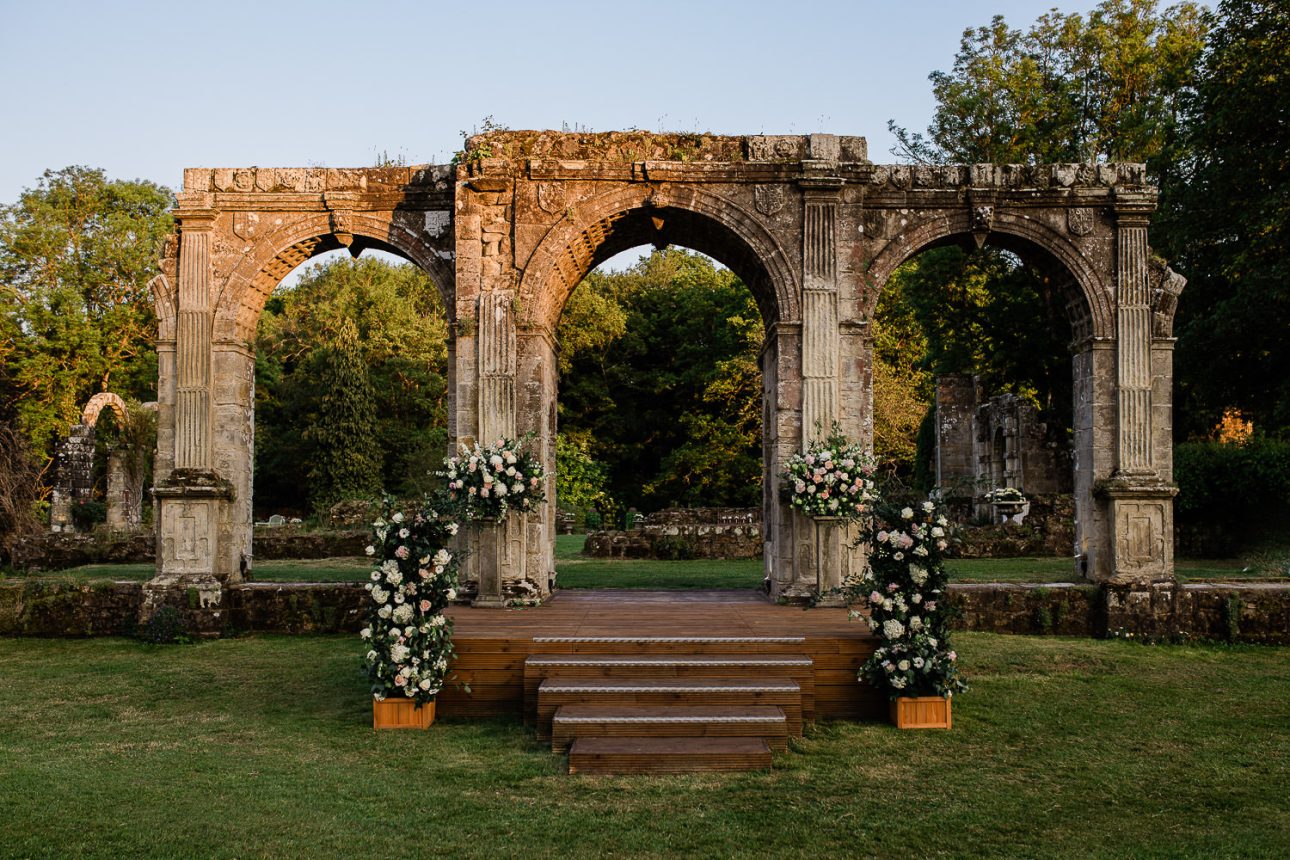 The sunset hits an elizabethan arch at an events venue near Horsham.