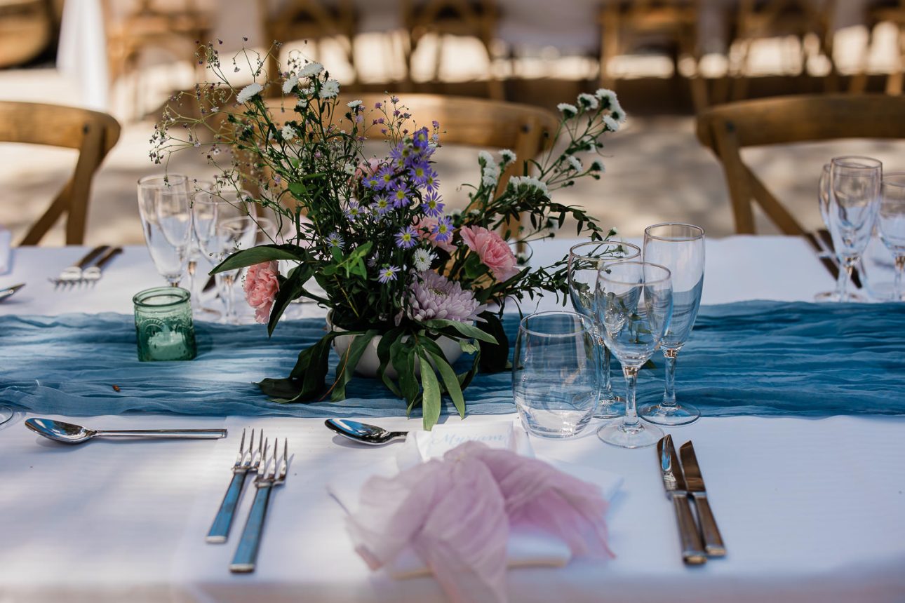 A table setting at a mediterranean themed outdoor reception at a french destination wedding.