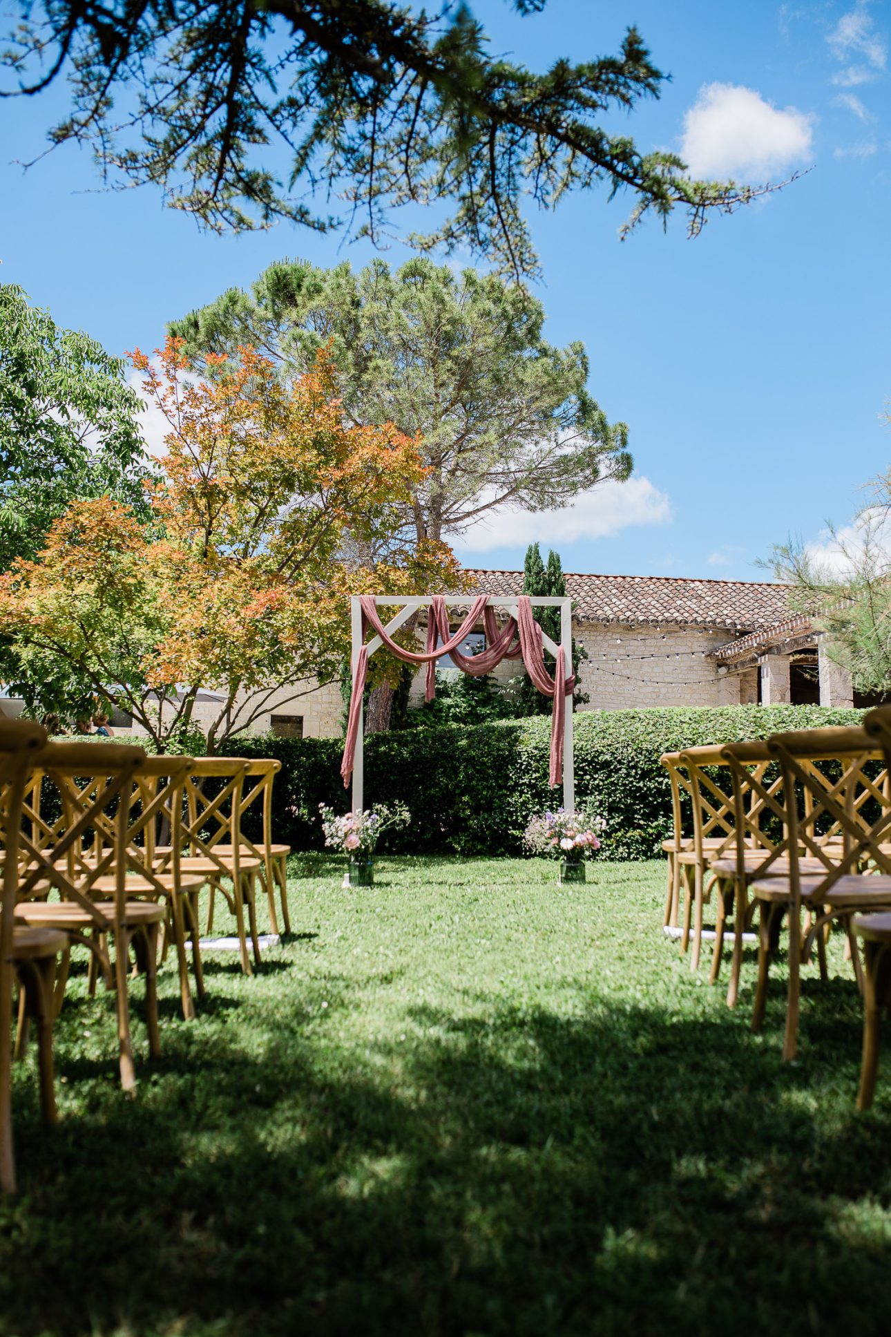An outdoor wedding ceremony in spring, for a mediterranean wedding in France.