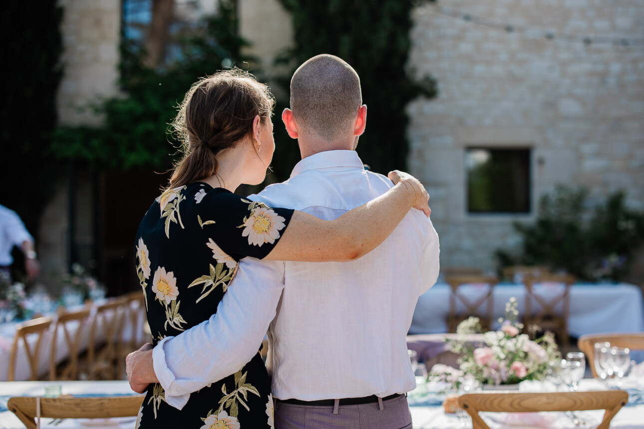 A couple embrace and look out at the wedding reception layout at domaine les gaillardoux in Toulouse.