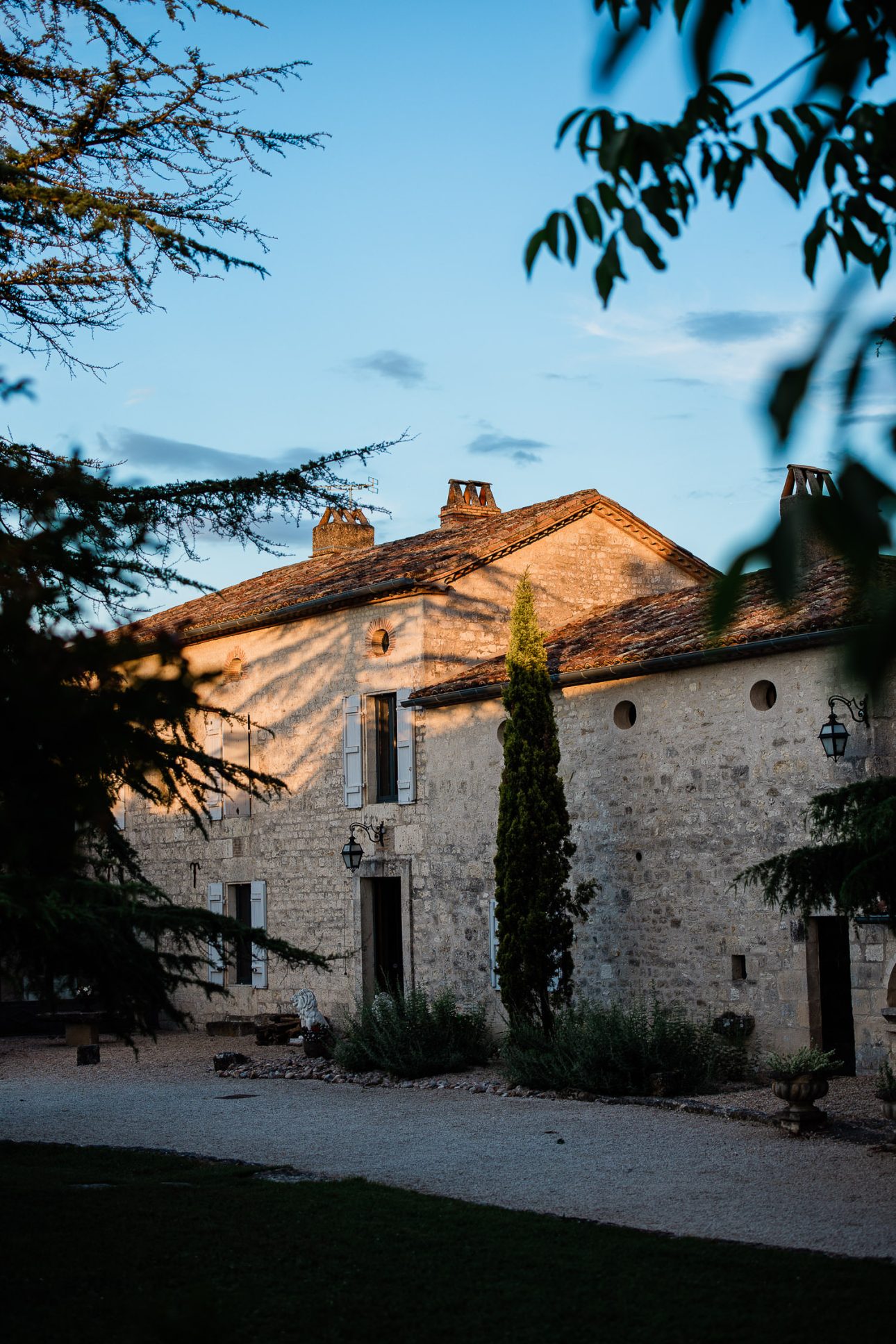 Golden light softly hits the top of a french country house at Domaine les Gaillardoux.