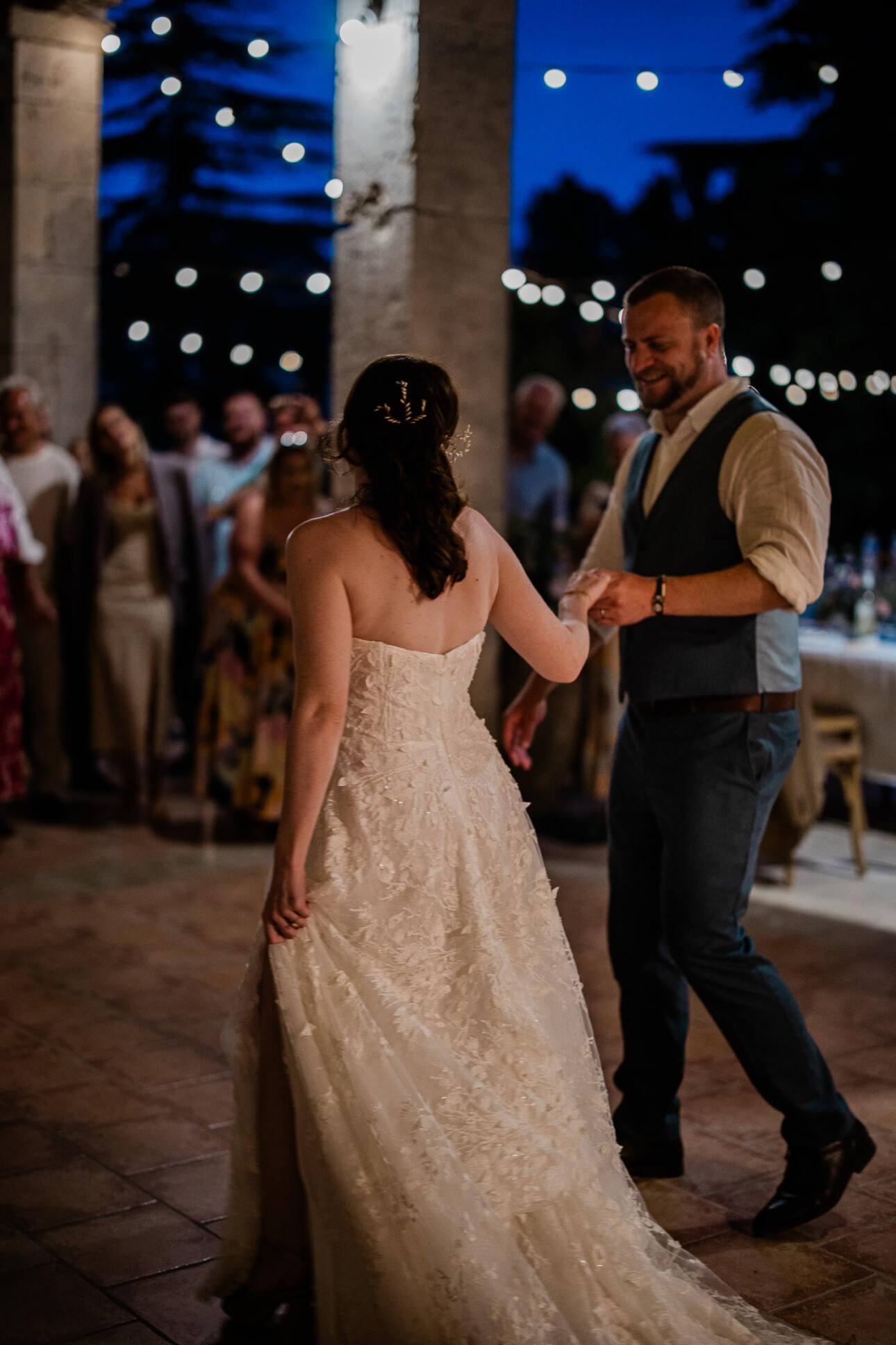 The newly weds walk out to the dancefloor at a french chateau wedding venue, about to start their first dance.