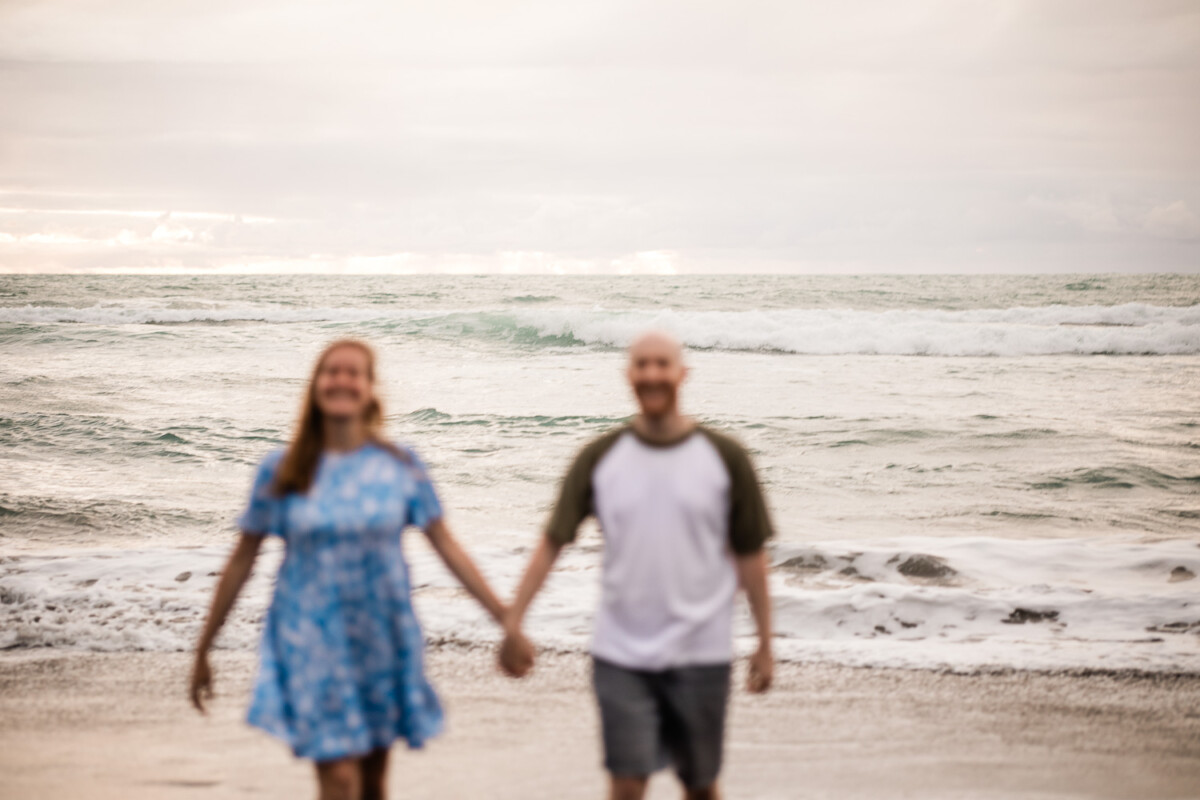 A couple walk together on a beach