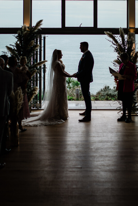 Polurrian on the Lizard wedding photography of a ceremony with a sea view