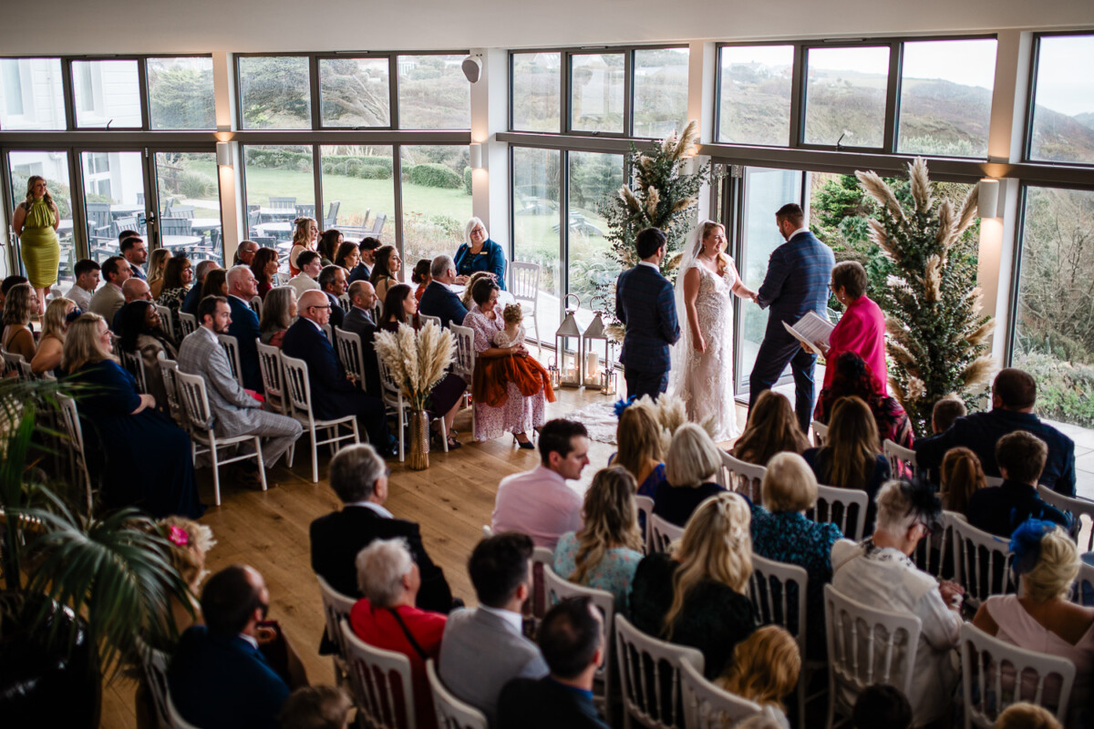 A bride and groom say their vows with their closest friends and family around them