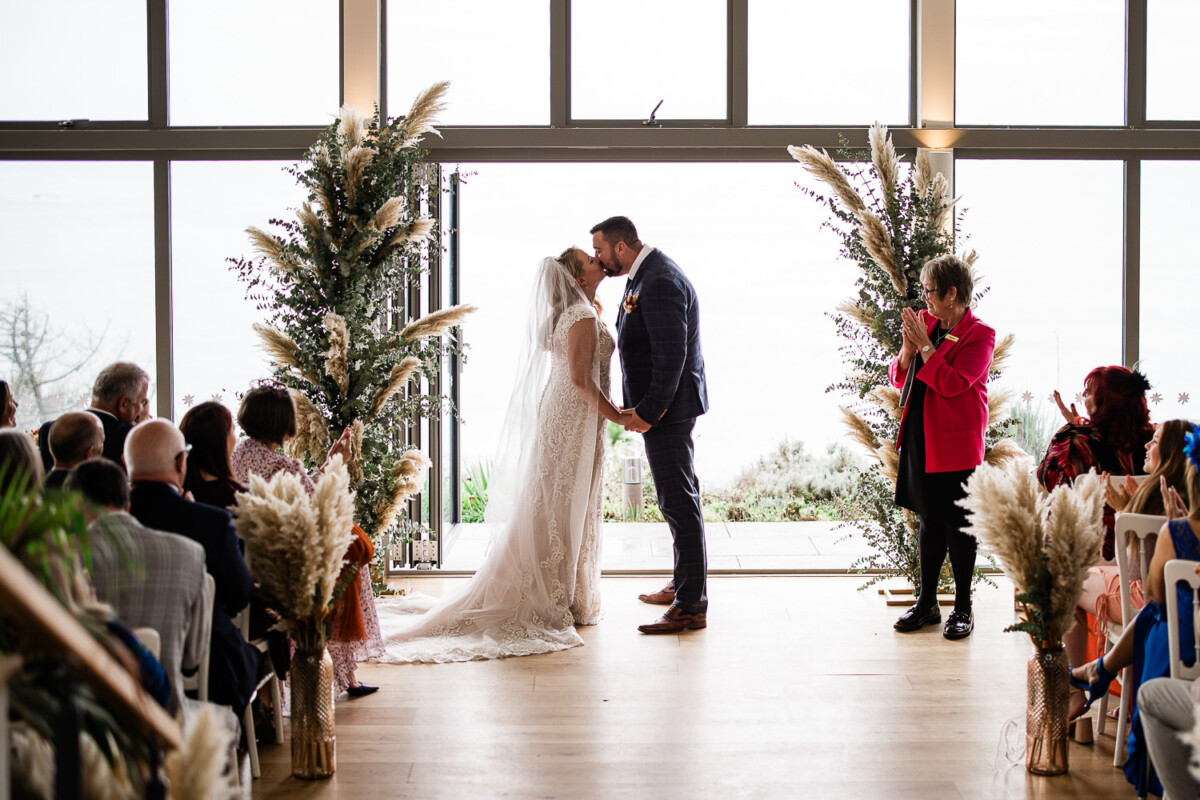 Polurrian on the lizard wedding photography of a bride and groom having their first kiss