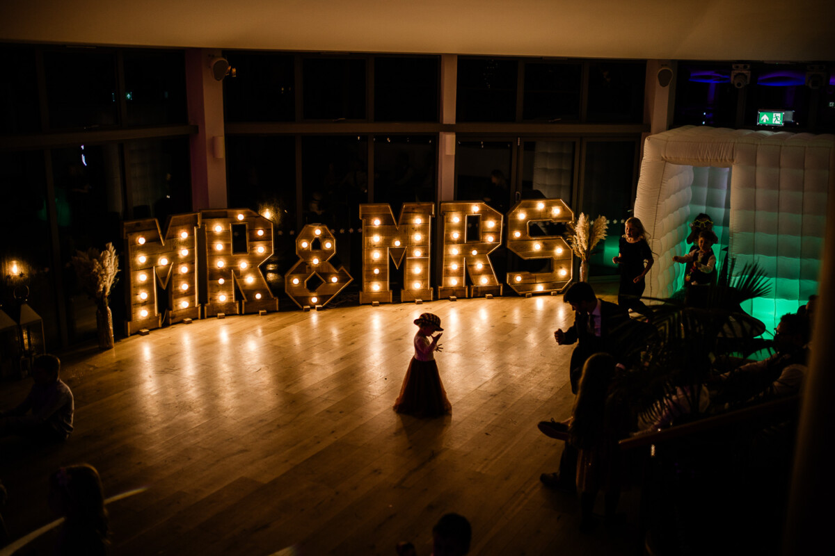 A girl dances alone on a dancefloor, for a Polurrian on the lizard wedding