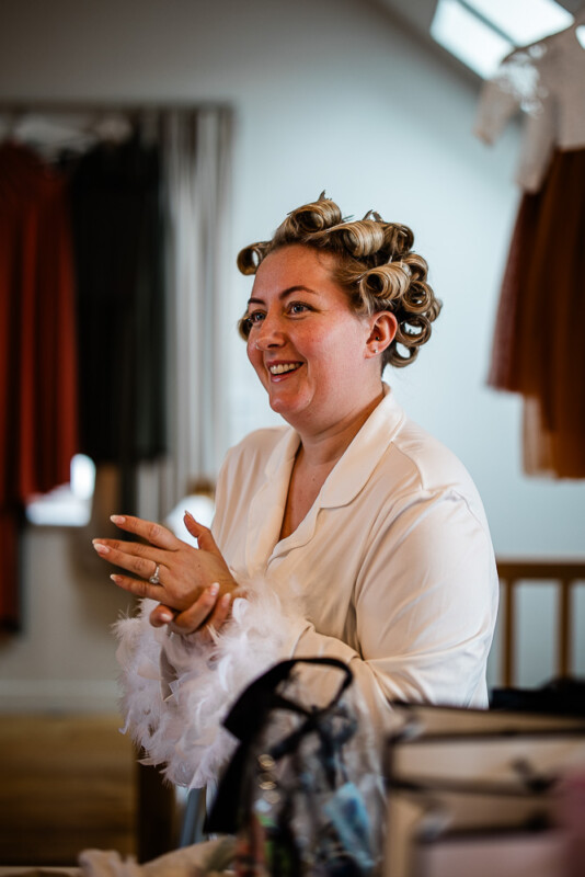 A bride smiles during bridal prep for a wedding in the South West of England