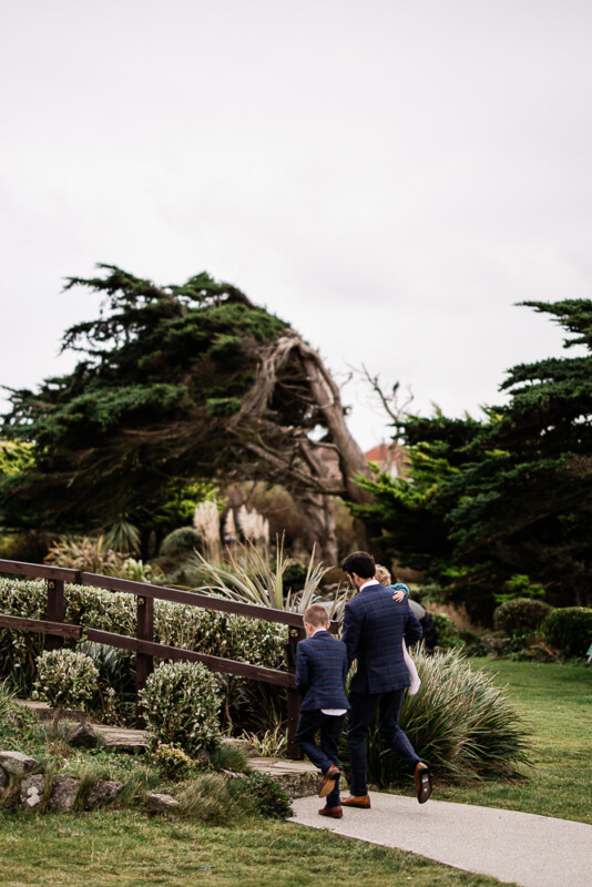 Wedding guests walk in the gardens for a Polurrian on the lizard wedding