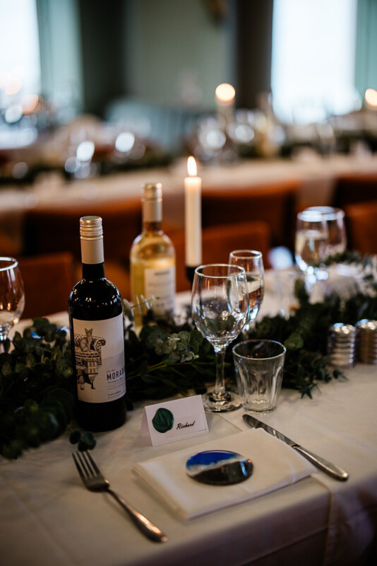 A place setting at an autumnal wedding reception, captured by a polurrian on the lizard wedding photographer