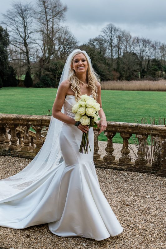 A bride walks through the gardens at south west wedding venues, Brympton House