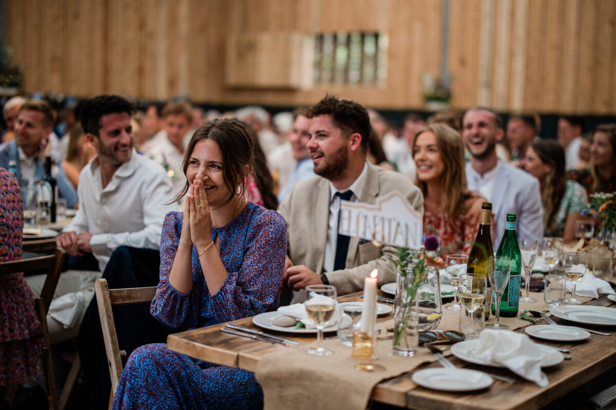 Wedding guests during speeches at The Grain Store, captured by a wedding photographer uk