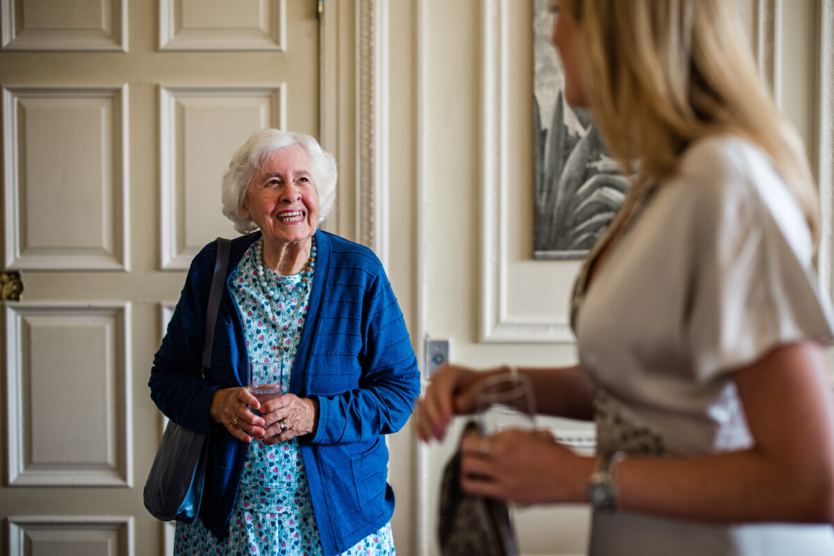 Guests chat during an intimate wedding ceremony at Bovey Castle in Devon