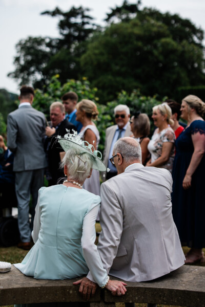 Reportage wedding photography of grandparents watching all the guests during the wedding