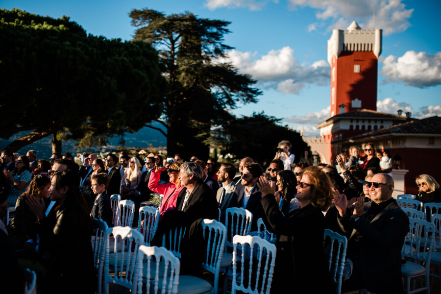 The guests cheer during an outdoor ceremony at Chateau cremat in France