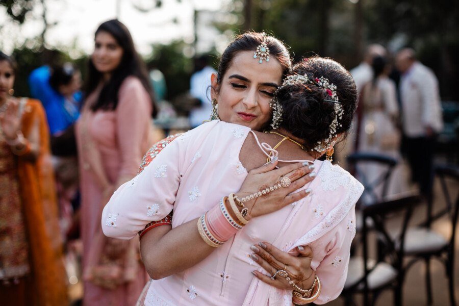 A bride hugs her mother, during a destination wedding in India